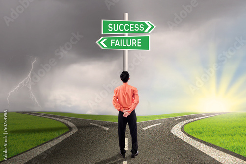 Photo: Businessman choosing success or failure road Businessman choosing success or failure road