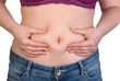 Woman measuring her belly fat
