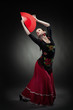 young woman dancing flamenco on black