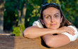Beautiful woman leaning on a fence