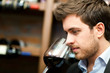 Man tasting a glass of red wine