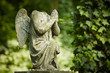 Cherub without head. Damaged statue on old cemetery.
