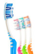 Photo: Composition with toothbrushes isolated on white Composition with toothbrushes isolated on white