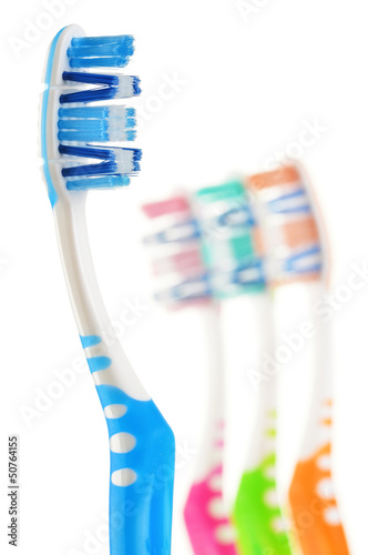 Photo: Composition with toothbrushes isolated on white Composition with toothbrushes isolated on white
