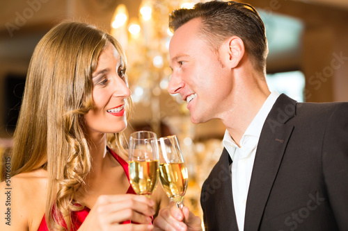 Photo: Man and woman tasting Champagne in restaurant Man and woman tasting Champagne in restaurant
