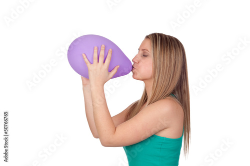 Photo: Attractive blond girl swelling a purple balloon Attractive blond girl swelling a purple balloon
