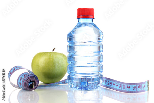 Photo: Bottle of water, apple and measuring tape isolated on white Bottle of water, apple and measuring tape isolated on white