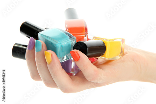Photo: woman hand with nail polishes isolated on white woman hand with nail polishes isolated on white