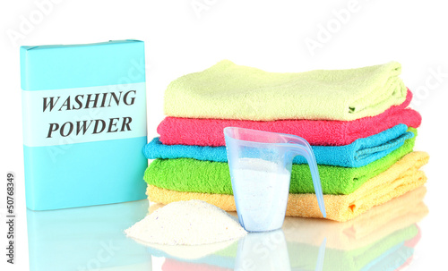 Photo: Box of washing powder with blue measuring cup and towels, Box of washing powder with blue measuring cup and towels,