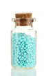 Little bottle full with colorful beads isolated on white