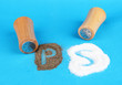 Salt and pepper shakers on color background