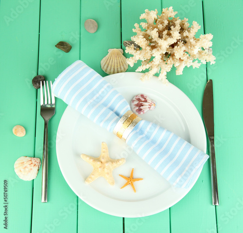 Photo: Marine table setting on color wooden background Marine table setting on color wooden background