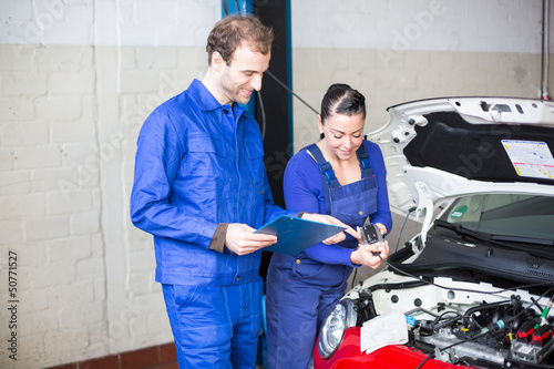 Photo: Car mechanics repairing the electrics Car mechanics repairing the electrics