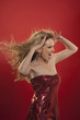 woman with blond hair and red dress screams