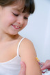 nurce giving vaccination injection to little girl patient
