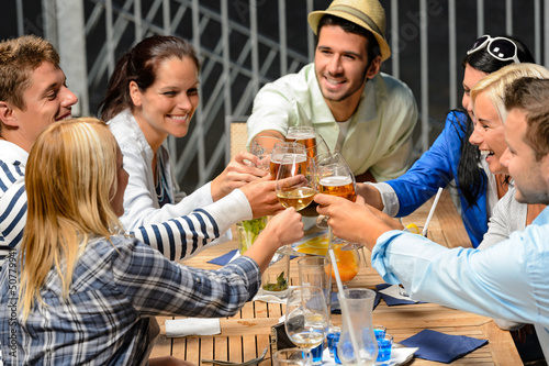 Photo: Group of cheerful people toasting with drinks Group of cheerful people toasting with drinks