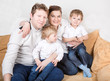 Happy family of a four having fun at home