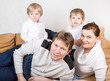 Happy family of a four having fun at home