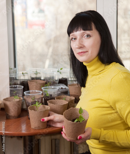 Photo: Female gardener with various seedlings Female gardener with various seedlings