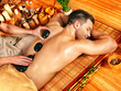 Photo: Man getting stone therapy massage . Man getting stone therapy massage .