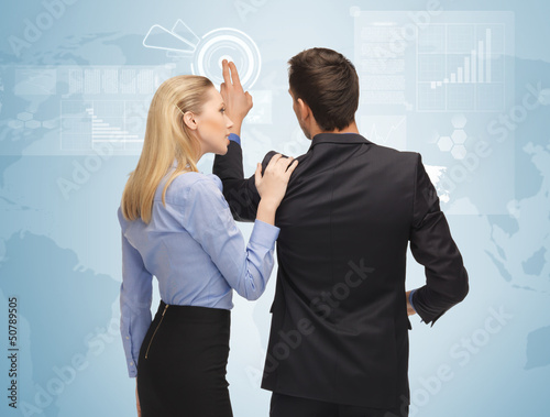 Photo: man and woman working with virtual screen man and woman working with virtual screen