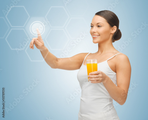 Photo: woman with glass of juice and virtual screen woman with glass of juice and virtual screen