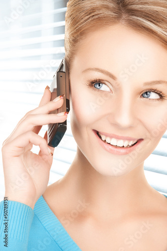 Photo: businesswoman with cell phone calling businesswoman with cell phone calling
