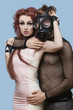Photo: Portrait of young man in gas mask embracing funky woman over blue background Portrait of young man in gas mask embracing funky woman over blue background