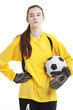Photo: Portrait of young female soccer player holding ball with hand on hip against white background Portrait of young female soccer player holding ball with hand on hip against white background