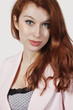 Photo: Portrait of beautiful young businesswoman in pink suit against gray background Portrait of beautiful young businesswoman in pink suit against gray background