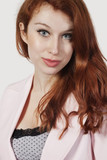 Photo: Portrait of beautiful young businesswoman in pink suit against gray background Portrait of beautiful young businesswoman in pink suit against gray background