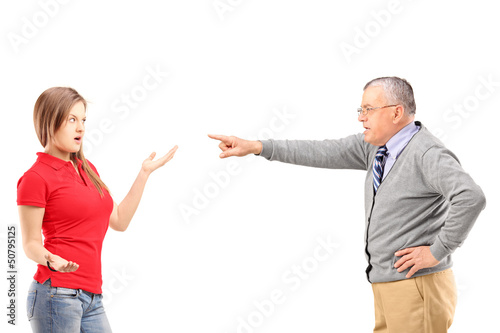 Photo: Angry father pointing at his daughter Angry father pointing at his daughter