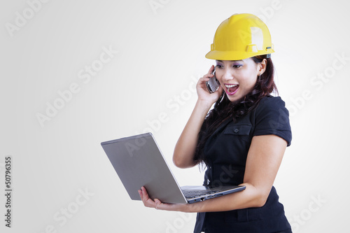 Photo: Architect laughing on the phone Architect laughing on the phone