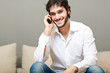 Relaxed young guy enjoying conversation on the sofa