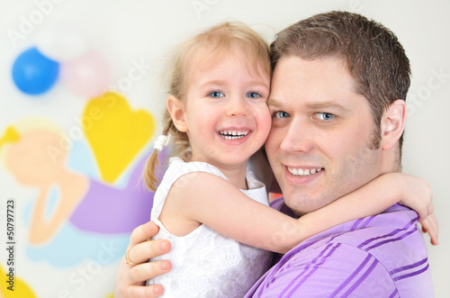 Photo: Father and daughter having fun in playroom Father and daughter having fun in playroom
