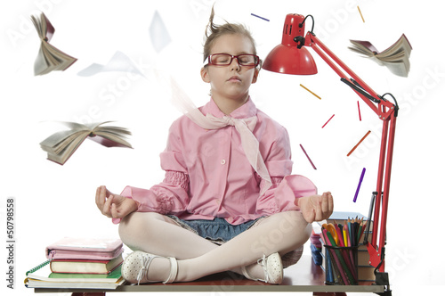Photo: Beautiful girl meditating on the desk Beautiful girl meditating on the desk