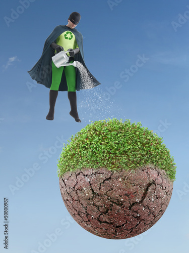 Photo: Eco superhero watering dried planet Eco superhero watering dried planet