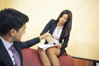 Asiatic Businesswoman receiving advances from young businessman