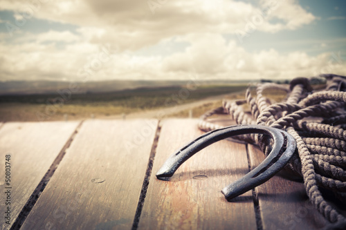 Photo: Iron horseshoe on a vintage background Iron horseshoe on a vintage background