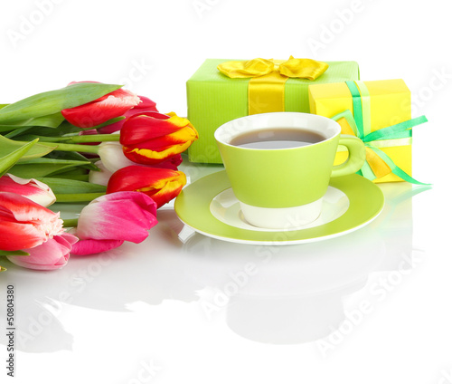 Photo: Beautiful tulips in bucket with gifts and cup of tea isolated Beautiful tulips in bucket with gifts and cup of tea isolated