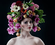 model with large hairstyle and flowers in her hair.