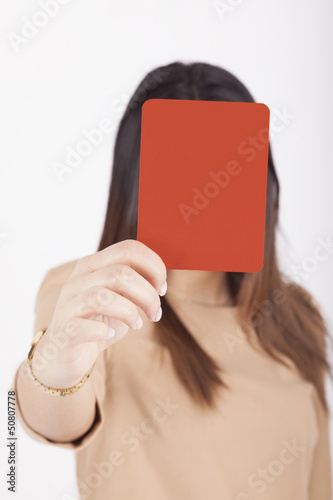 Photo: business woman showing red card business woman showing red card