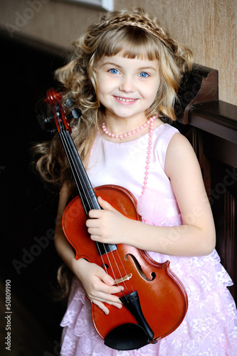 Photo: portrait of a little girl with a violin portrait of a little girl with a violin
