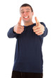 Happy young man with a funny face giving a big like.