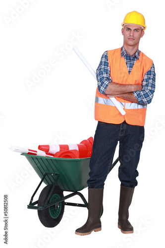 Photo: Angry tradesman standing in front of a wheelbarrow Angry tradesman standing in front of a wheelbarrow