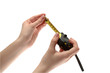 woman's hands with manicure hold measure tape