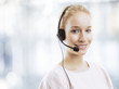 Confident young female customer service agent with headset