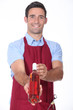 Waiter offering bottle of wine