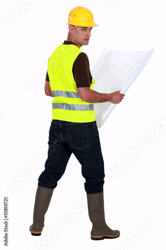Photo: Tradesman looking at a blueprint Tradesman looking at a blueprint