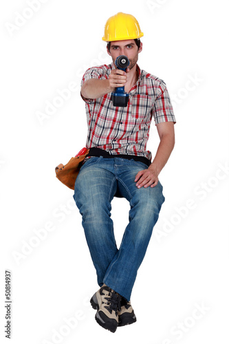 Photo: Laborer holding a drill Laborer holding a drill